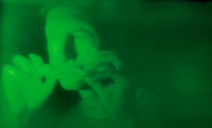 An image of a man bathed in green light
