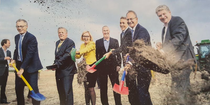 An image of a group of people digging soil